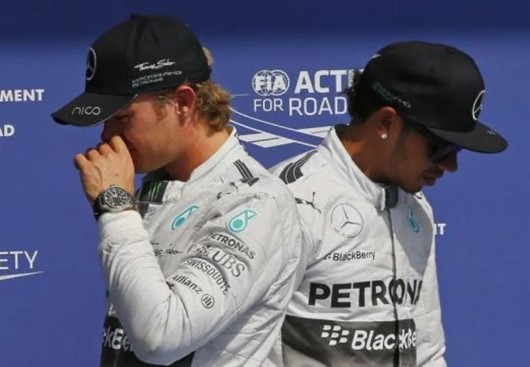 Mercedes Formula One driver Nico Rosberg (L) of Germany and team mate Lewis Hamilton of Britain walk next to each other after the qualifying session at the Belgian F1 Grand Prix in Spa-Francorchamps August 23, 2014. REUTERS/Yves Herman