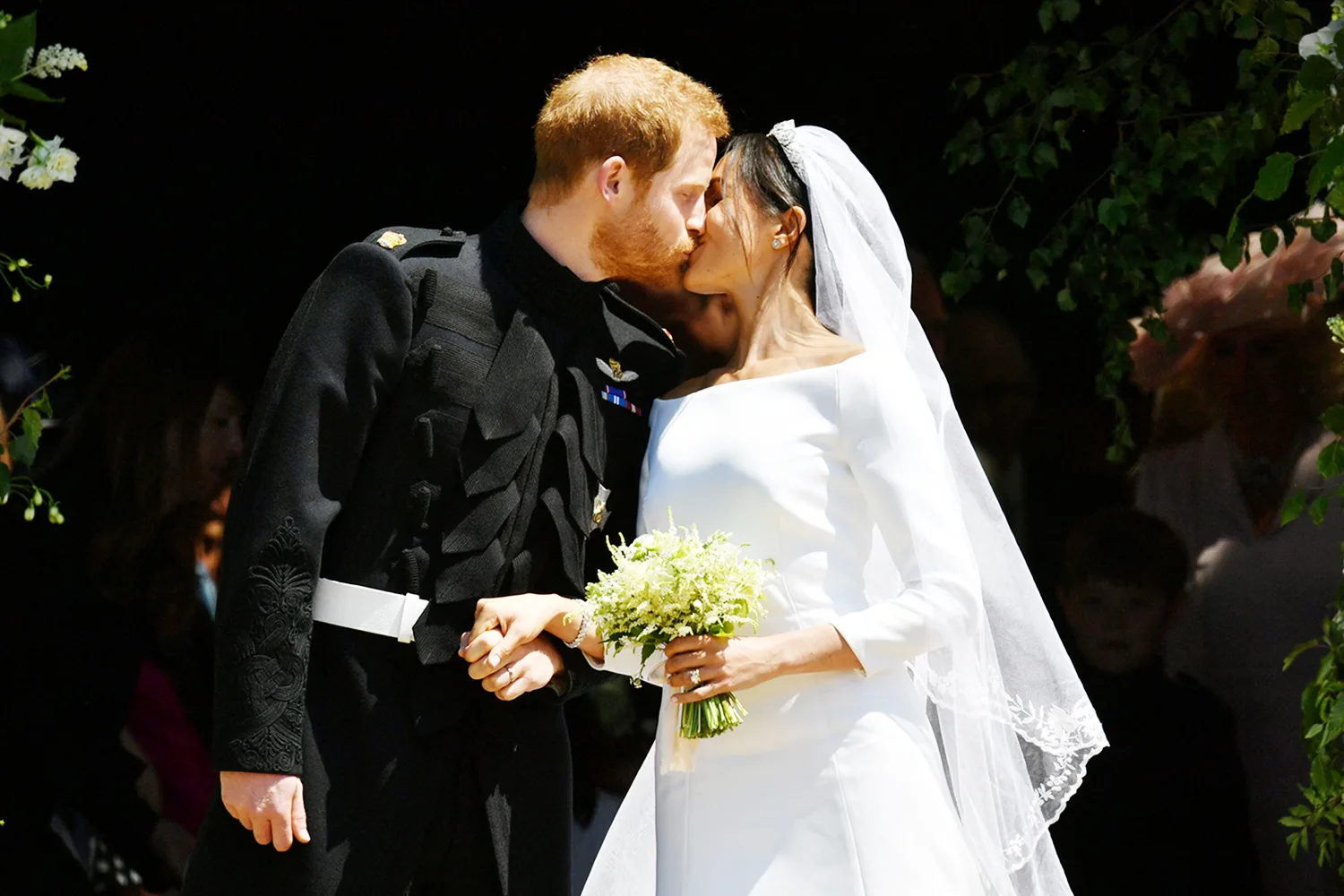 Prince Harry and Meghan Markle kiss on the steps of St George’s Chapel in Windsor Castle after their wedding. Saturday May 19, 2018. Ben Birchall/Pool via REUTERS