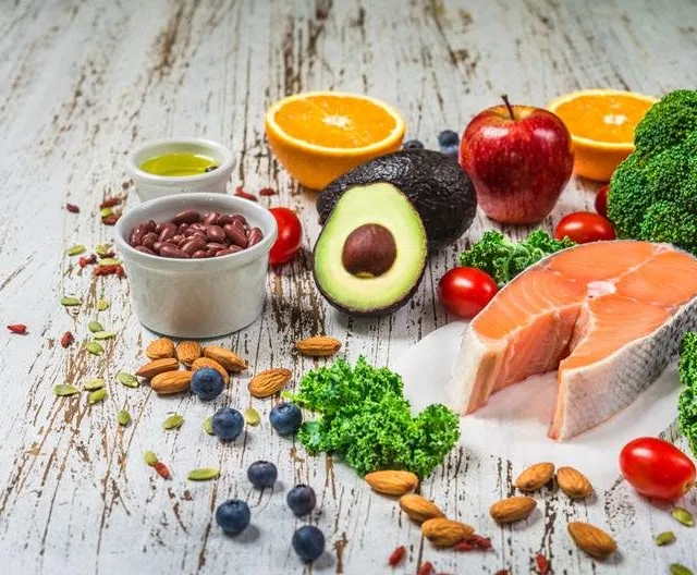 Selection of fresh fruit and vegetables, salmon, beans, and nuts. Concept of cooking and eating healthy food, fitness, dieting, vegetarian, and lifestyle. Ingredients good for heart and diabetes.