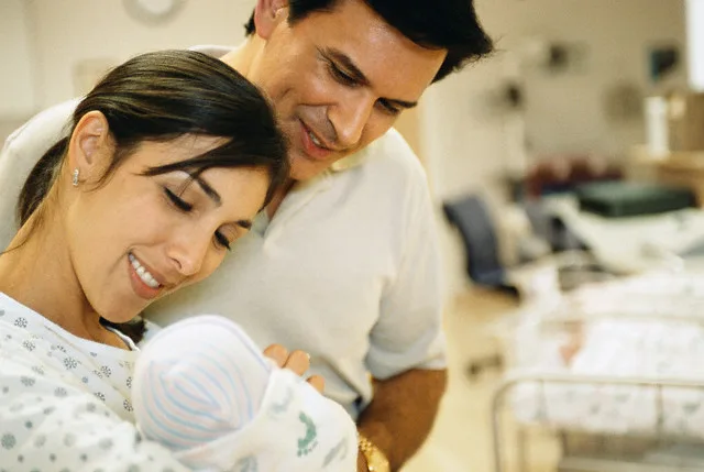 New Mother and Father with Their Newborn — Image by © Brooklyn Production/Corbis