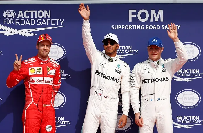 Formula One – F1 – Belgian Grand Prix – Spa-Francorchamps, Belgium – August 26, 2017 – Mercedes’ Lewis Hamilton celebrates his pole position next to Ferrari’s Sebastian Vettel and Mercedes’ Valtteri Bottas after qualifying session. REUTERS/Francois Lenoir