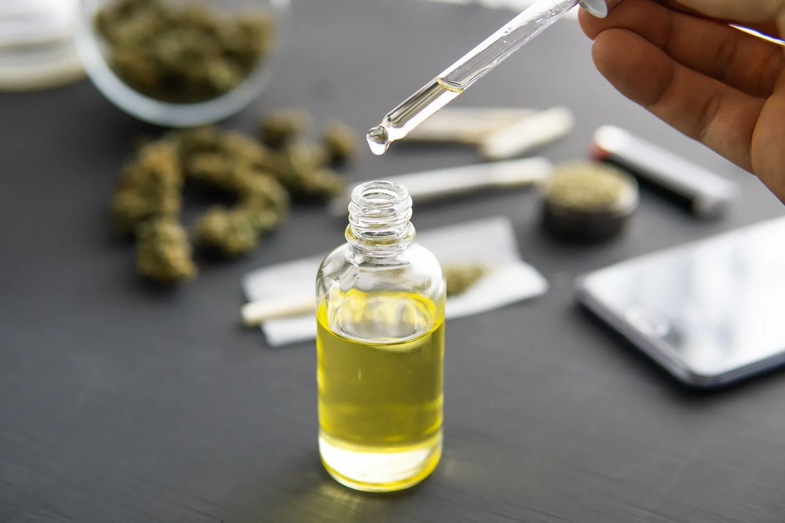 natural herb, CBD cannabis OIL. hemp product, Cannabis oil in pipette, medical marijuana concept, close up,