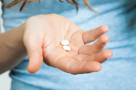 Close-up of hand holding pills