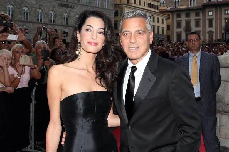 FLORENCE, ITALY – SEPTEMBER 05: Amal Alamuddin and George Clooney attend the Celebrity Fight Night In Italy Benefitting The Andrea Bocelli Foundation and The Muhammad Ali Parkinson Center Gala on September 7, 2014 in Florence, Italy. (Photo by Andrew Goodman/Getty Images for Celebrity Fight Night) Generated by IJG JPEG Library