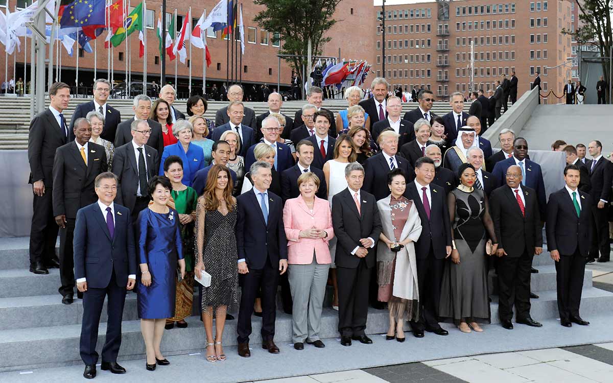 Participants of the G20 summit and their spouses pose for a family photo around German Chancellor Angela Merkel (5thL) and her husband Joachim Sauer (6thL) at the Elbphilharmonie before attending a concert in Hamburg, Germany, July 7, 2017. REUTERS/LUDOVIC MARIN/Pool