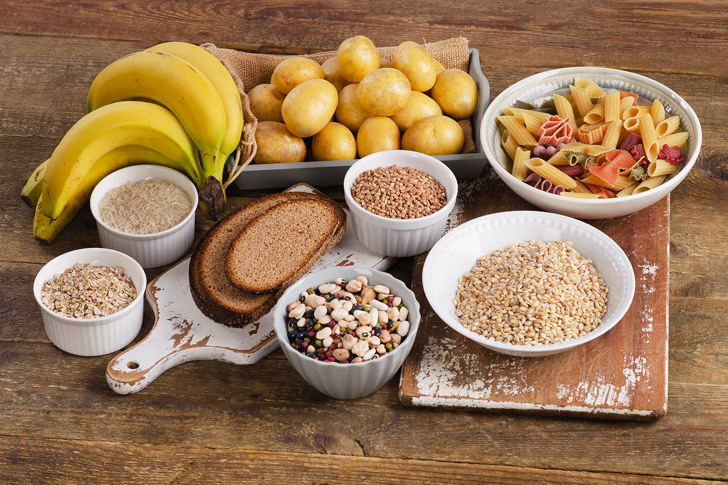 Foods high in carbohydrate on wooden background. Top view