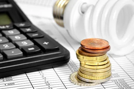 Compact Fluorescent Lightbulb, calculator and coin stack