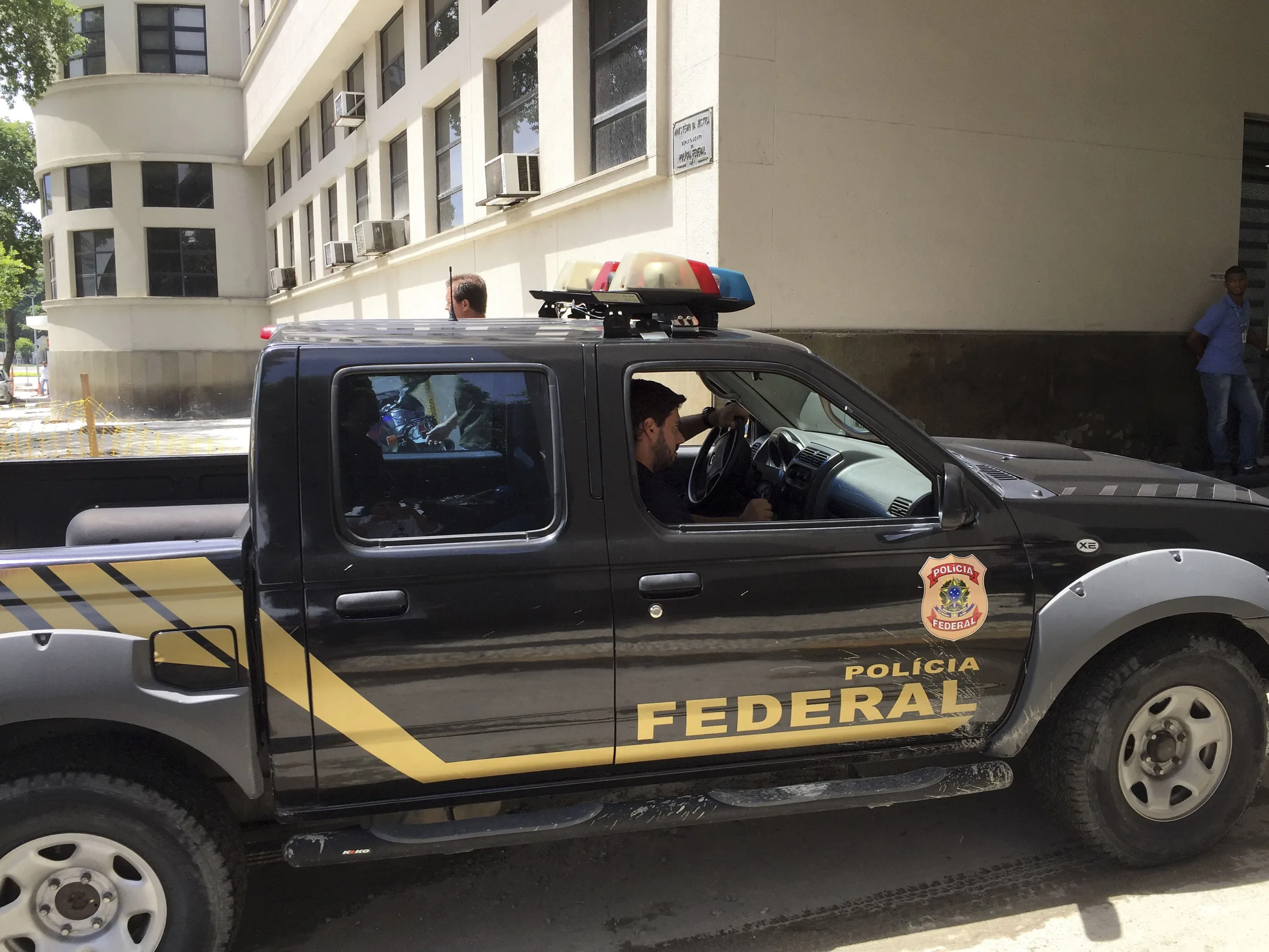 Rio de Janeiro – Agente chega à sede da Polícia Federal, no Rio de Janeiro, levando malotes (Cristina Índio do Brasil/Agência Brasil)