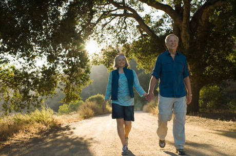 Mature couple walking down dirt road