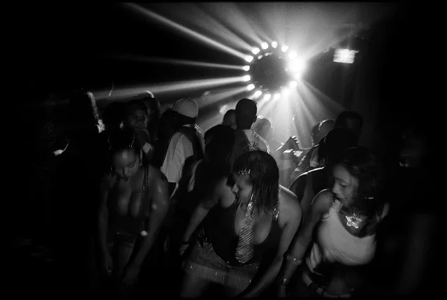 Girls dance at a Baile Funk party in Rocinha, Rio de Janeiro, on May 5, 2008. The lyrics of the “Baile” songs often talk about the violence and crime and became the representation of the current problems residents faced in Rio.