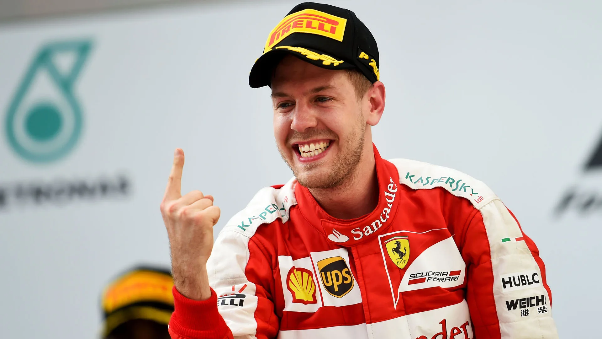 KUALA LUMPUR, MALAYSIA – MARCH 29: Sebastian Vettel of Germany and Ferrari celebrates on the podium after winning the Malaysia Formula One Grand Prix at Sepang Circuit on March 29, 2015 in Kuala Lumpur, Malaysia. (Photo by Lars Baron/Getty Images)