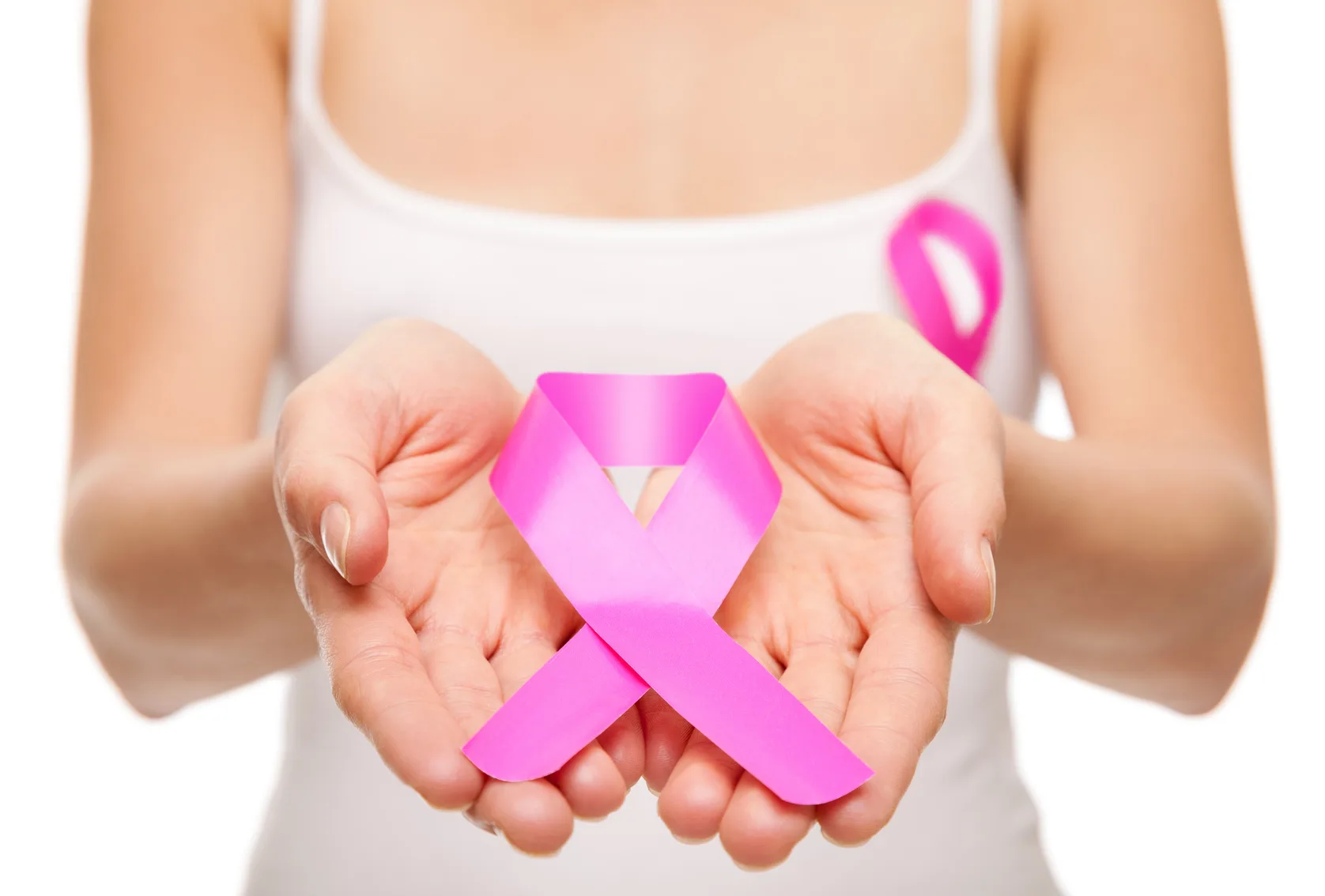 Woman holding a pink cancer awareness ribbon in her hands