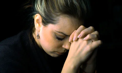 a woman is praying to god with hope