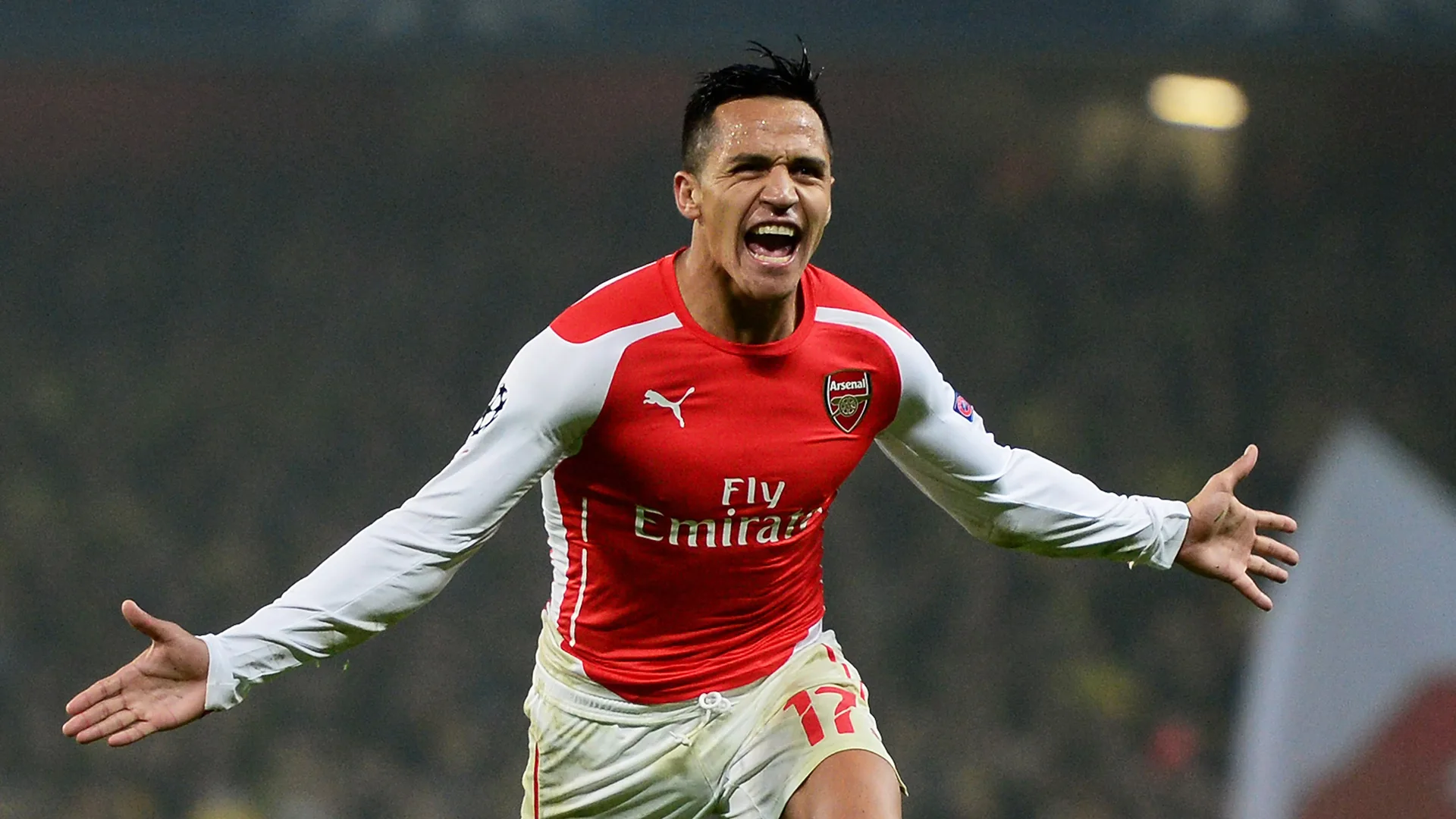 LONDON, ENGLAND – NOVEMBER 26: Alexis Sanchez of Arsenal celebrates after scoring his team’s second goal during the UEFA Champions League Group D match between Arsenal and Borussia Dortmund at the Emirates Stadium on November 26, 2014 in London, United Kingdom. (Photo by Jamie McDonald/Getty Images)