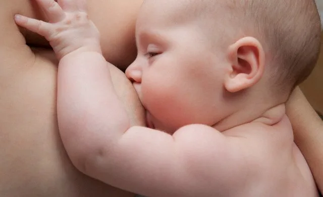 Baby girl (2-5 months) breast feeding, close-up — Image by © Wolfgang Weinhaupl/Westend61/Corbis