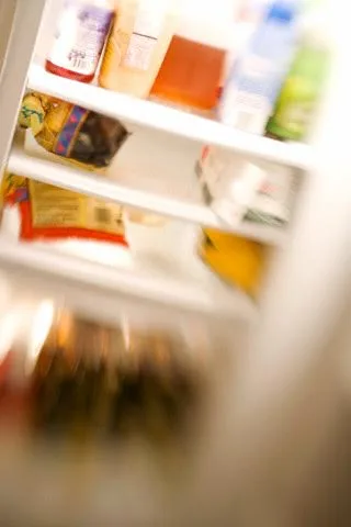 Blurry interior of stocked white refrigerator — Image by © Dana Hoff/Beateworks/Corbis