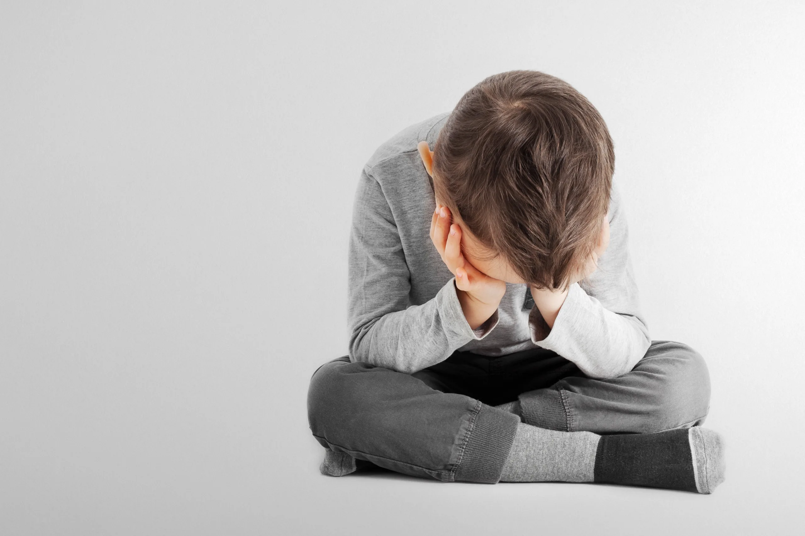 child whose depression is sitting on the floor