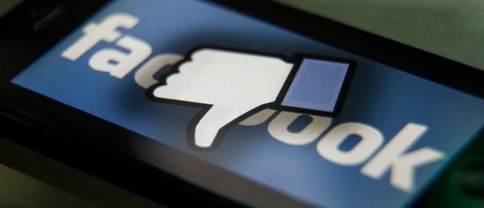 07 Oct 2014, Los Angeles, California, USA — Facebook thumbs-down hand on a iPhone. Facebook is a social media company owned by Mark Zuckerberg. — Image by © Ted Soqui/Corbis