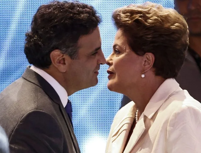 Presidential candidate for the Brazilian Workers’ Party and current President Dilma Rousseff (R) greets Brazilian Social Democracy Party candidate Aecio Neves before a television debate in Sao Paulo, Brazil on July 26, 2014. Brazilian general elections will take place next October 5. AFP PHOTO / Miguel SCHINCARIOL