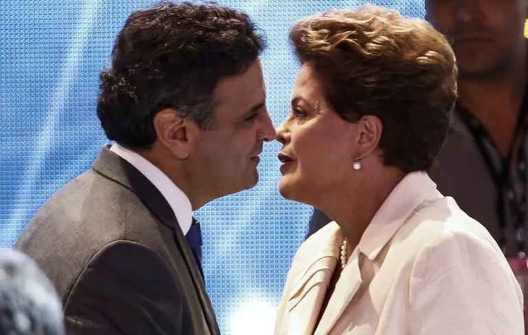 Presidential candidate for the Brazilian Workers’ Party and current President Dilma Rousseff (R) greets Brazilian Social Democracy Party candidate Aecio Neves before a television debate in Sao Paulo, Brazil on July 26, 2014. Brazilian general elections will take place next October 5. AFP PHOTO / Miguel SCHINCARIOL