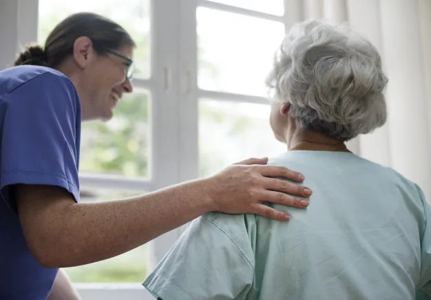 Nurse taking care of an old woman