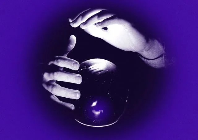 Fortuneteller’s Hands Above Crystal Ball — Image by © Corbis