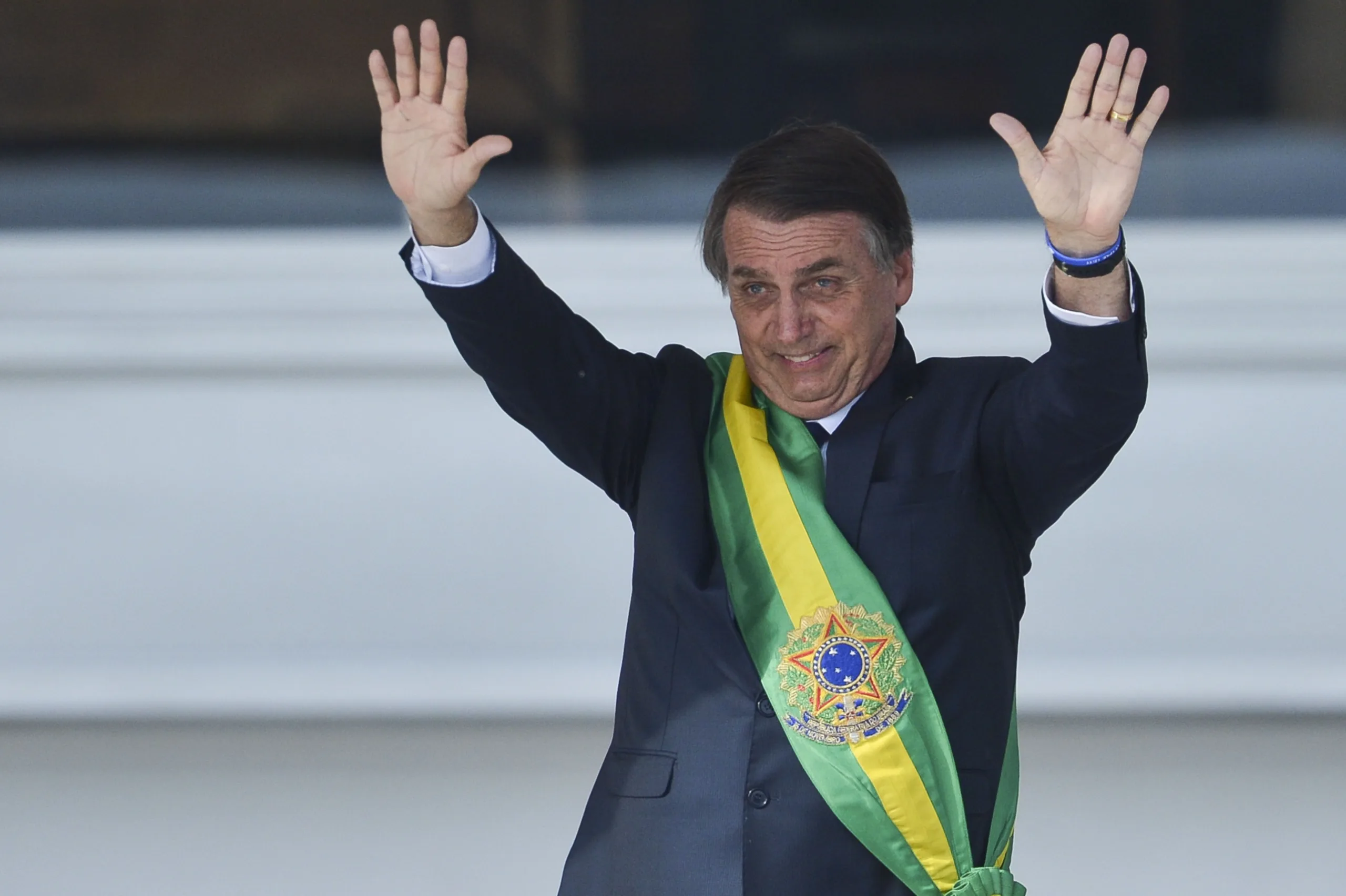 Presidente Jair Bolsonaro, saúda o público depois de receber a faixa presidencial de Michel Temer, no Palácio do Planalto.