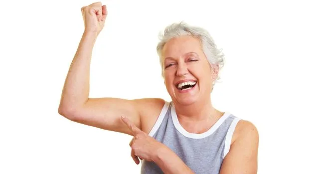 Senior woman showing her muscles