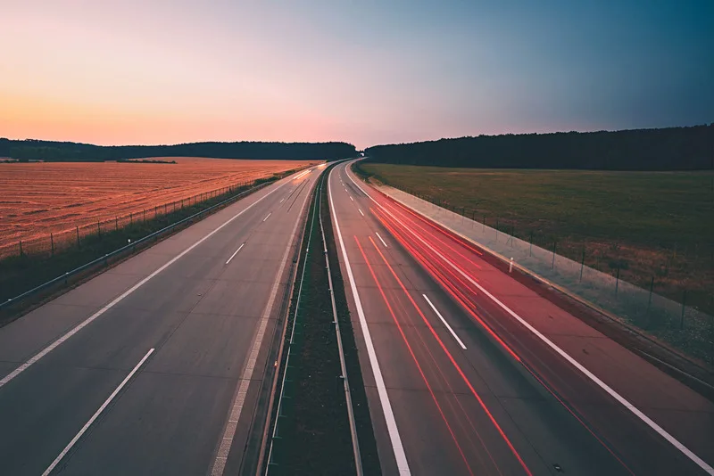 Traffic on the highway at the sunrise