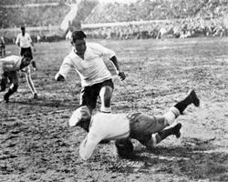 Argentina’s goalkeeper Juan Botasso dives bravely at the feet of Uruguay’s Hector Castro