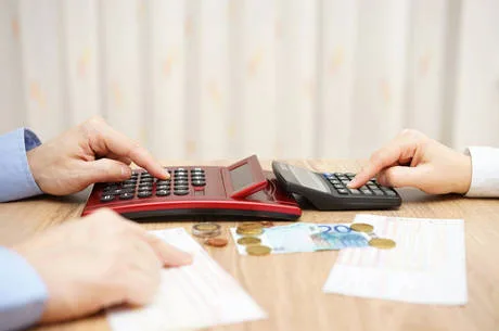 husband and wife are calculating monthly expenses. tight budget concept