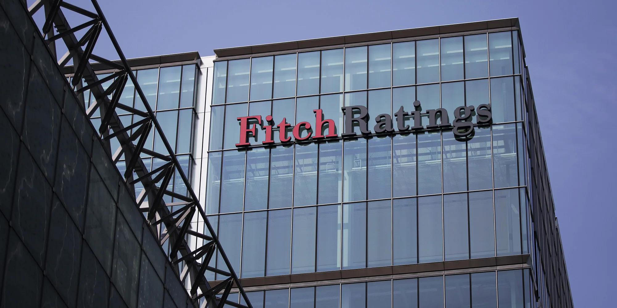 The headquarters of Fitch Ratings Ltd. stands in the Canary Wharf business and shopping district in London, U.K., on Friday, July 12, 2013. Recent data suggest Britain’s economic recovery is gaining momentum after a return to growth in the first quarter. Photographer: Simon Dawson/Bloomberg via Getty Images