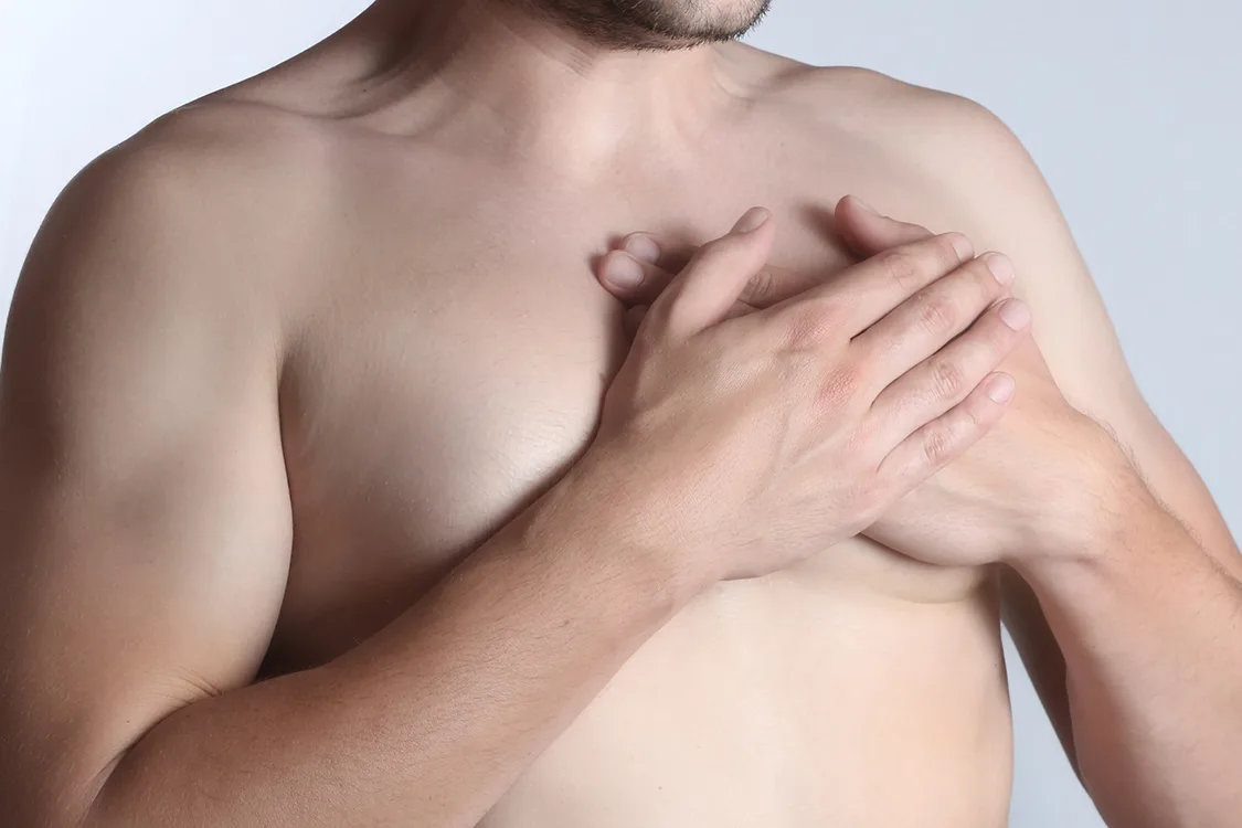 Young man holding hand to spot chest pain