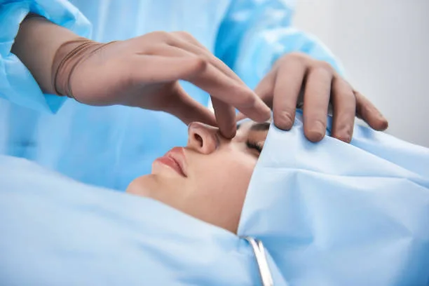 Close up photo of doctor hands palpating nose before operation