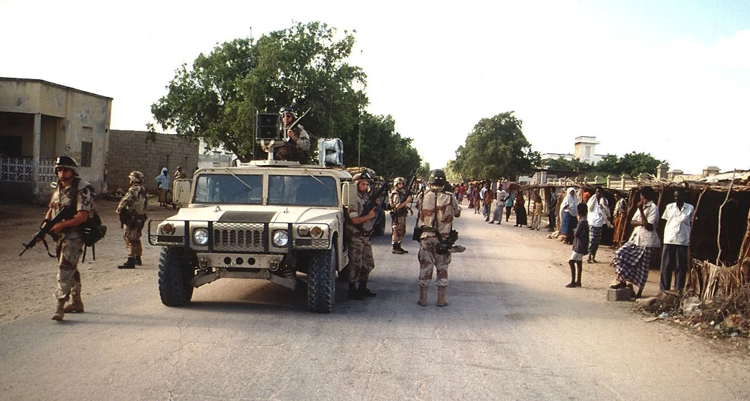 US Army soldiers coming down a street in Kismayo, Somalia. Soldiers from the 9th PSYOPS, Fort Bragg, North Carolina, ride in M998 High-Mobility Multipurpose Wheeled Vehicle (HMMWV) broadcasting messages to the Somali locals that line the street on both sides. Elements of the 10th M ountain Division, Fort Drum, New York, walk along side the […]