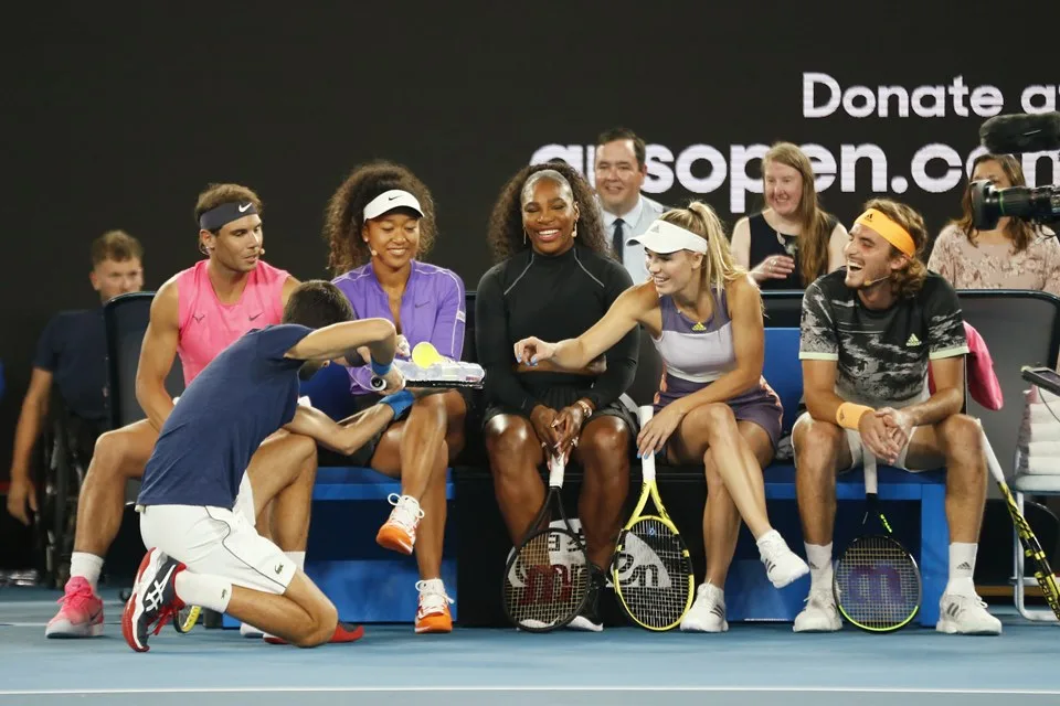 MELBOURNE, AUSTRALIA – JANUARY 15: Novak Djokovic of Serbia serves drinks during the Rally for Relief Bushfire Appeal event at Rod Laver Arena on January 15, 2020 in Melbourne, Australia. (Photo by Darrian Traynor/Getty Images)