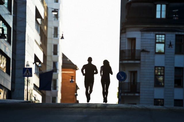 01 Aug 2012 — Couple running on road, Stockholm, Sweden — Image by © Hans Berggren/Johnér Images/Corbis