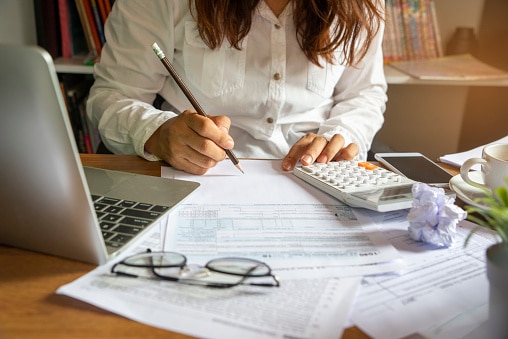 Budget planning concept,Accountant is calculating company's annual tax.Calendar 2019 and personal income tax forms for those who have income under US law placed on office desk.This is the season to pay taxes.