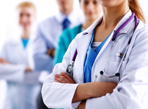 Attractive female doctor in front of medical group