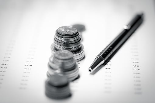 Close-up Coins and Pen on Financial Report, Business Accounting