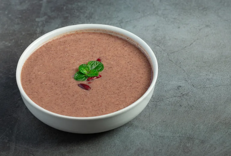 red bean hot soup in white bowl place on dark floor
