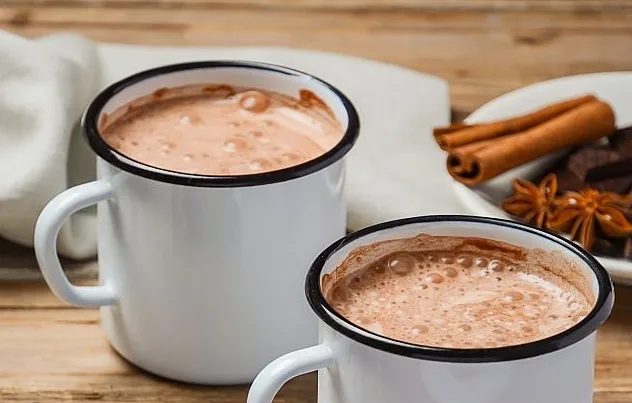 Hot chocolate on rustic wooden table, selective focus