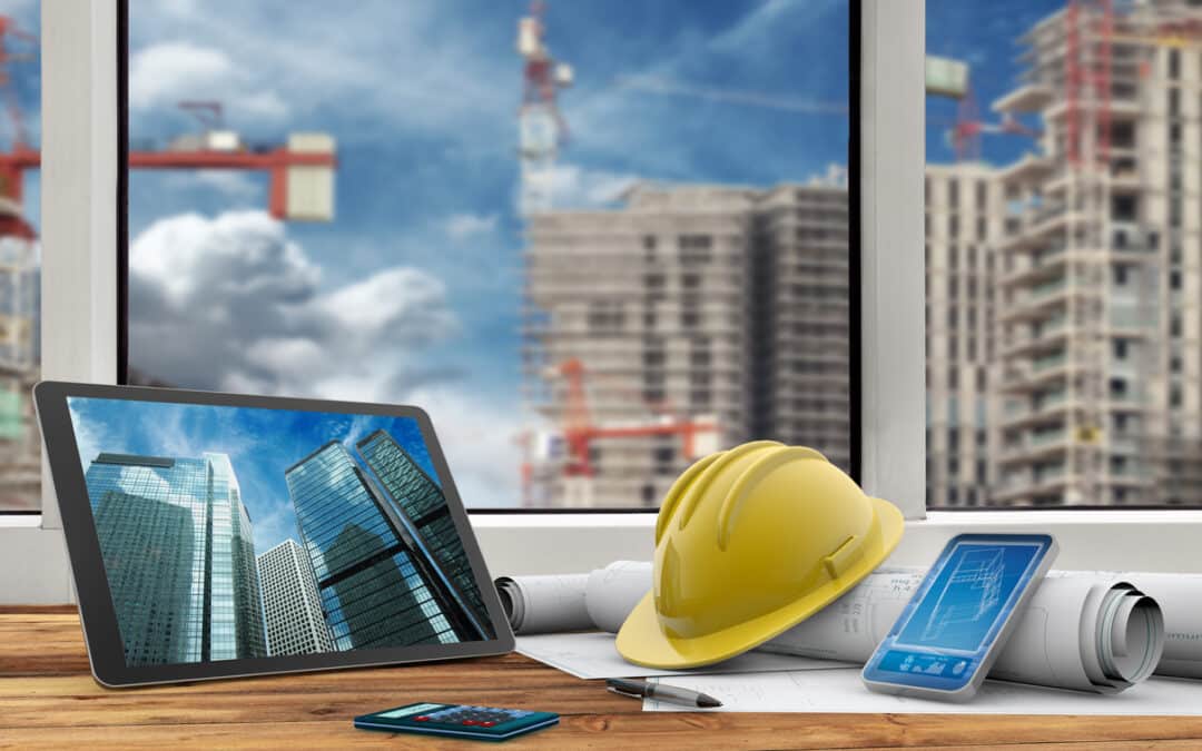 tablet, smartphone, safety helmet and blueprints in construction site