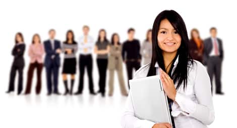 business team with a businesswoman holding a laptop computer - isolated over a white background