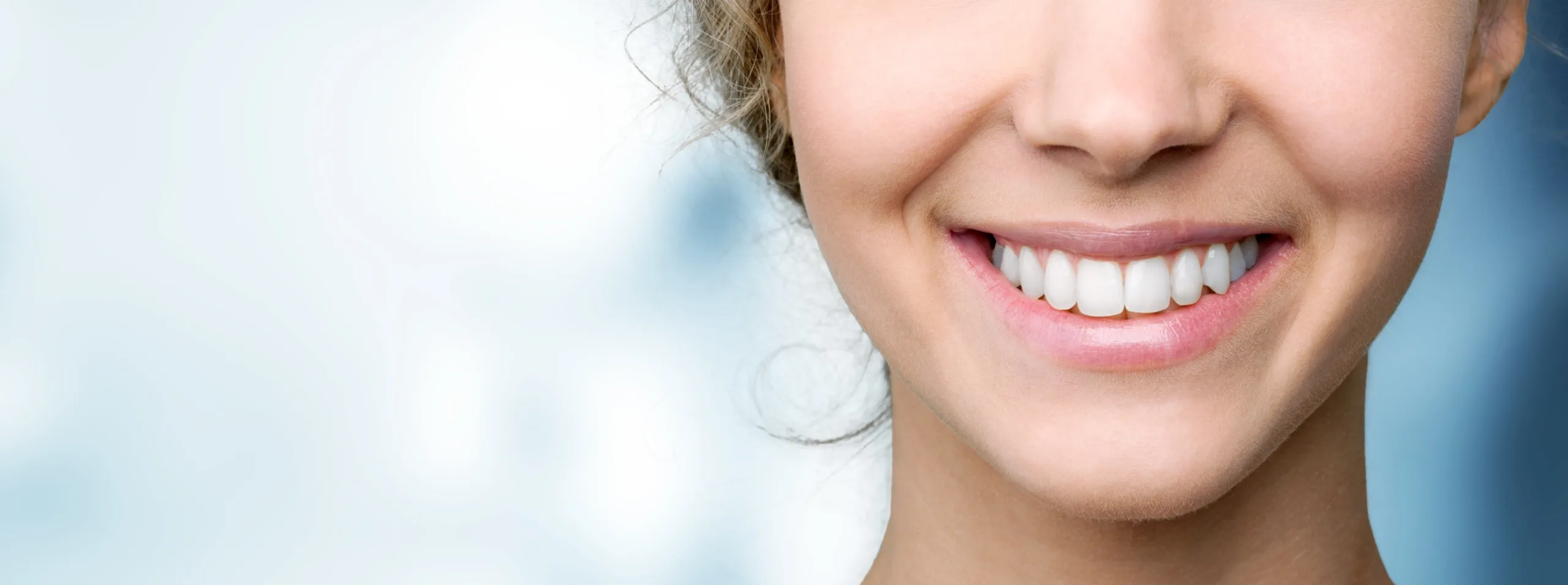 Beautiful wide smile of young fresh woman with great healthy white teeth. Isolated over background