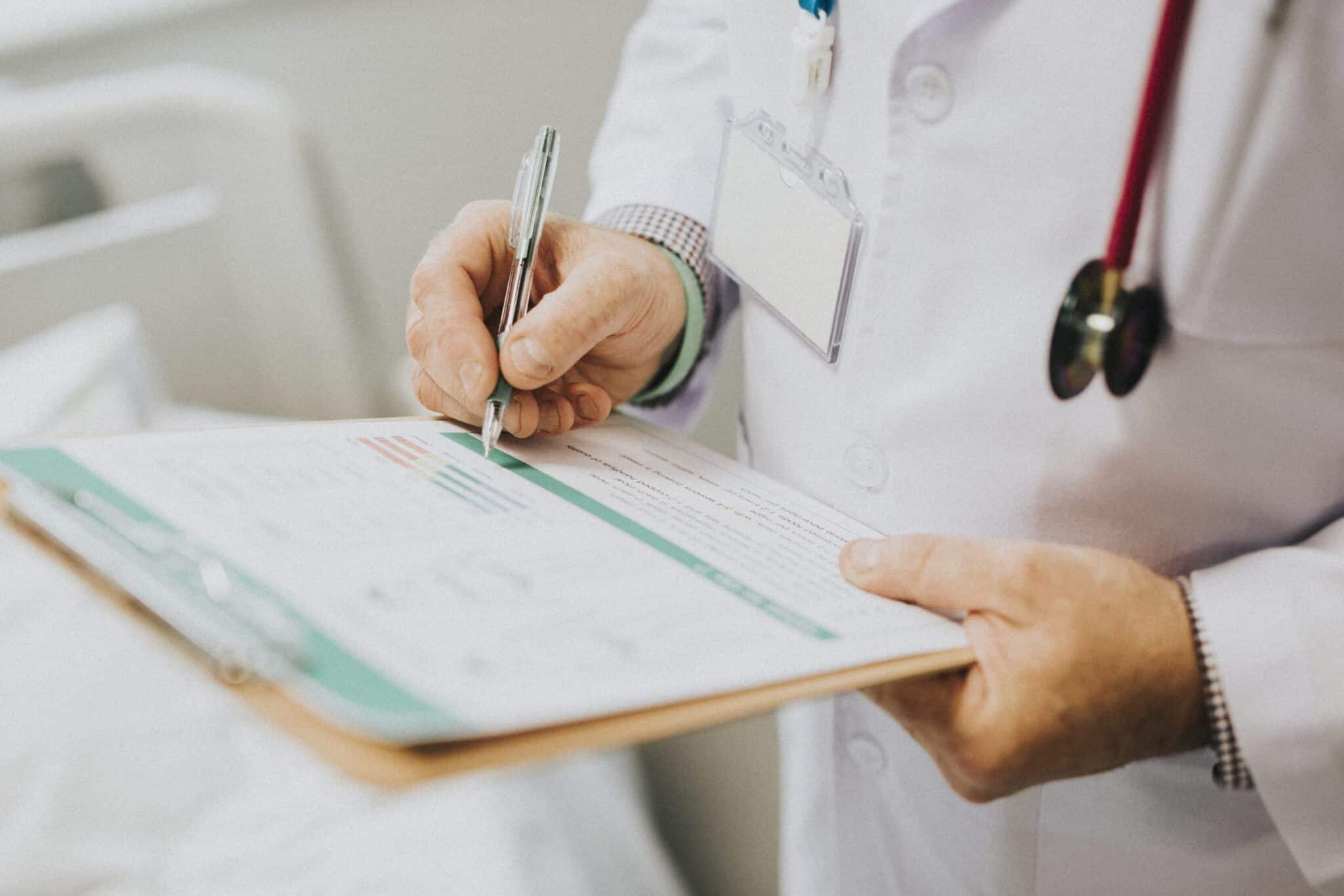 Physician noting down symptoms of a patient