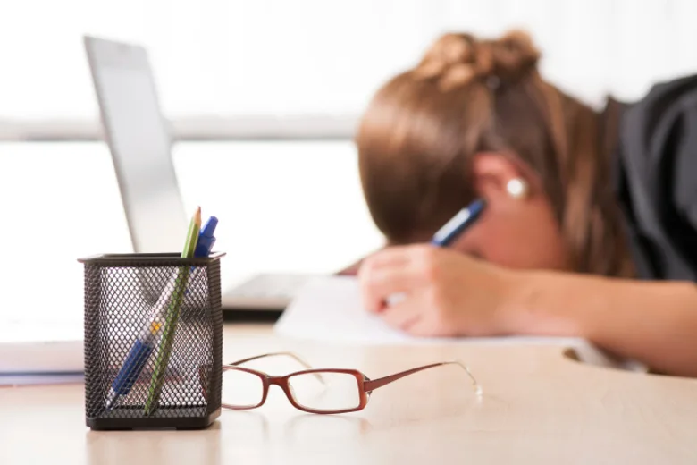 Exhausted woman sleeping at work