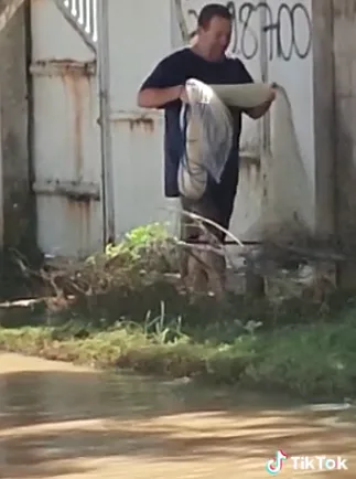 VÍDEO | Homem pesca com rede em rua alagada de Guriri, em São Mateus