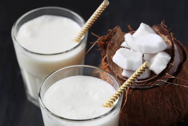 Refreshing drink. Delicious coconut cocktail with a straw