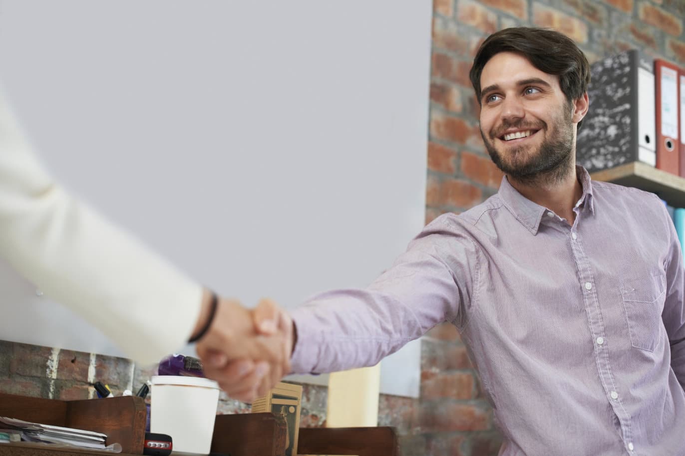 A young business man shaking hands with someone